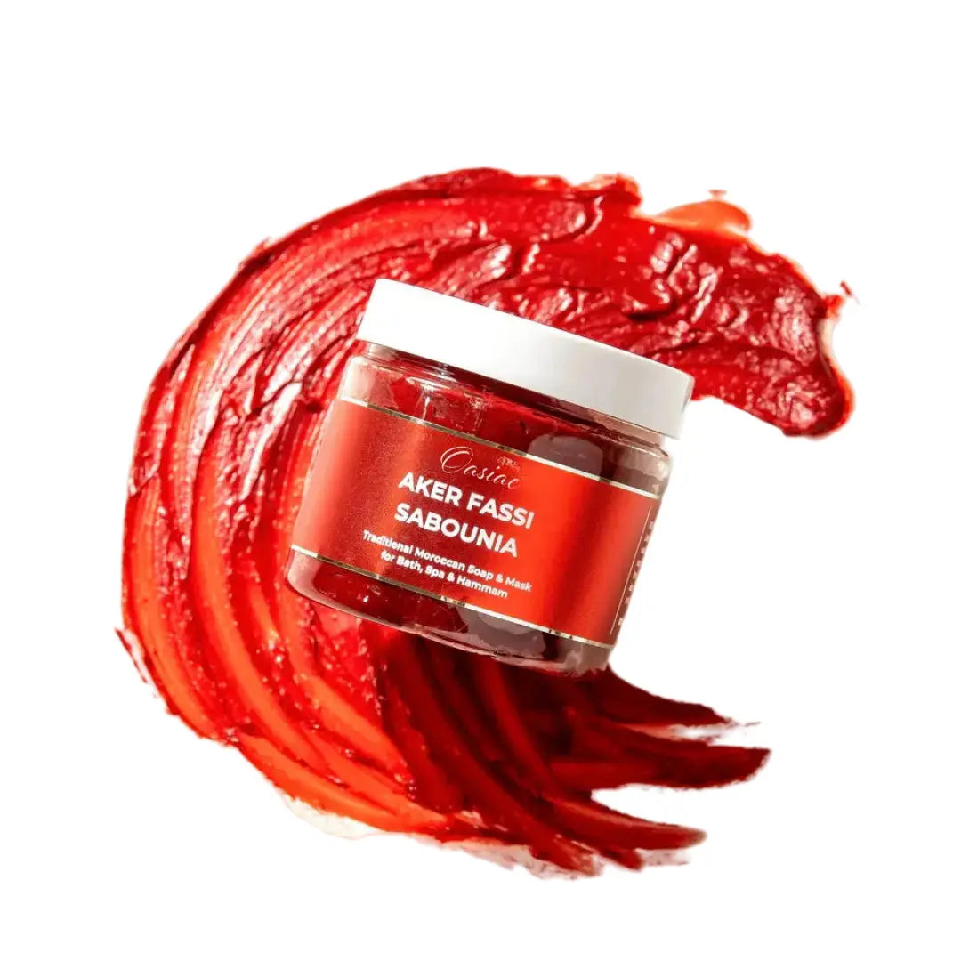 Red cosmetic jar with white lid on a red textured background